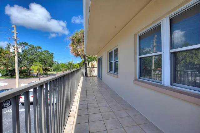 a view of balcony with wooden floor and fence