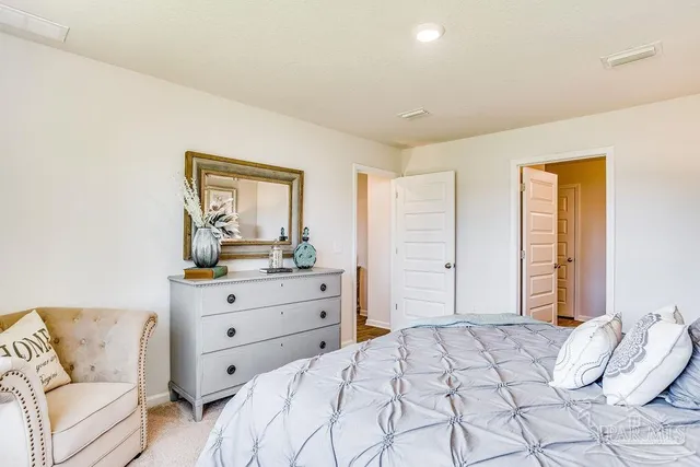 a bedroom with a bed and a couch