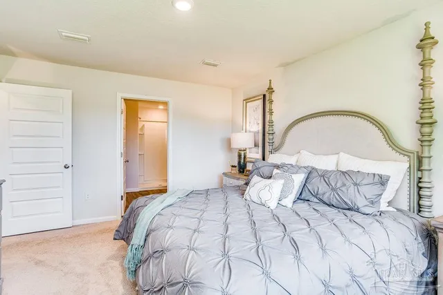 a bedroom with a bed and a dresser