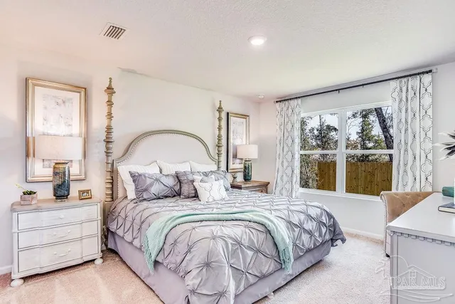 a bedroom with a bed and a large window