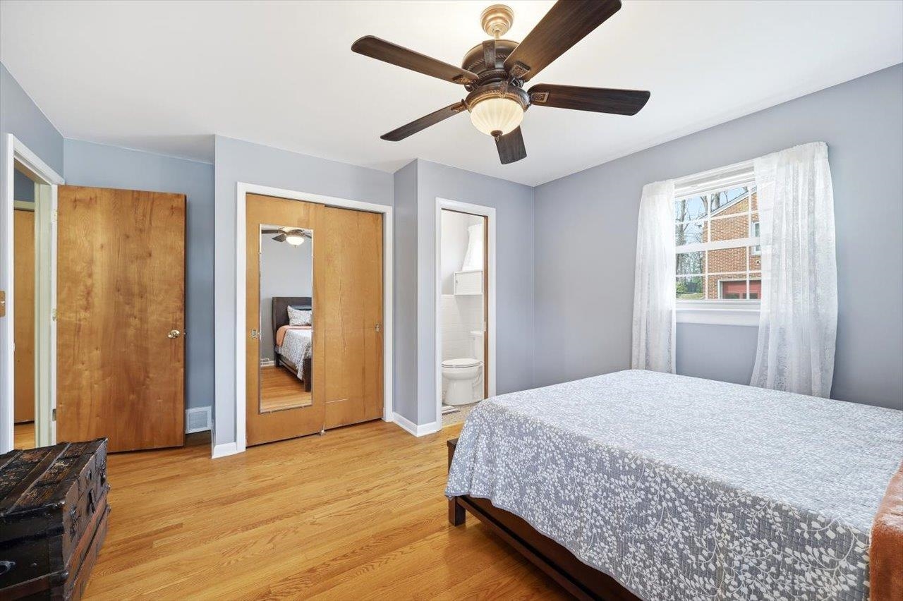 408 Robin Street Staunton, VA 24401 - Photo 15 of 52 a bedroom with a large bed chandelier and a window