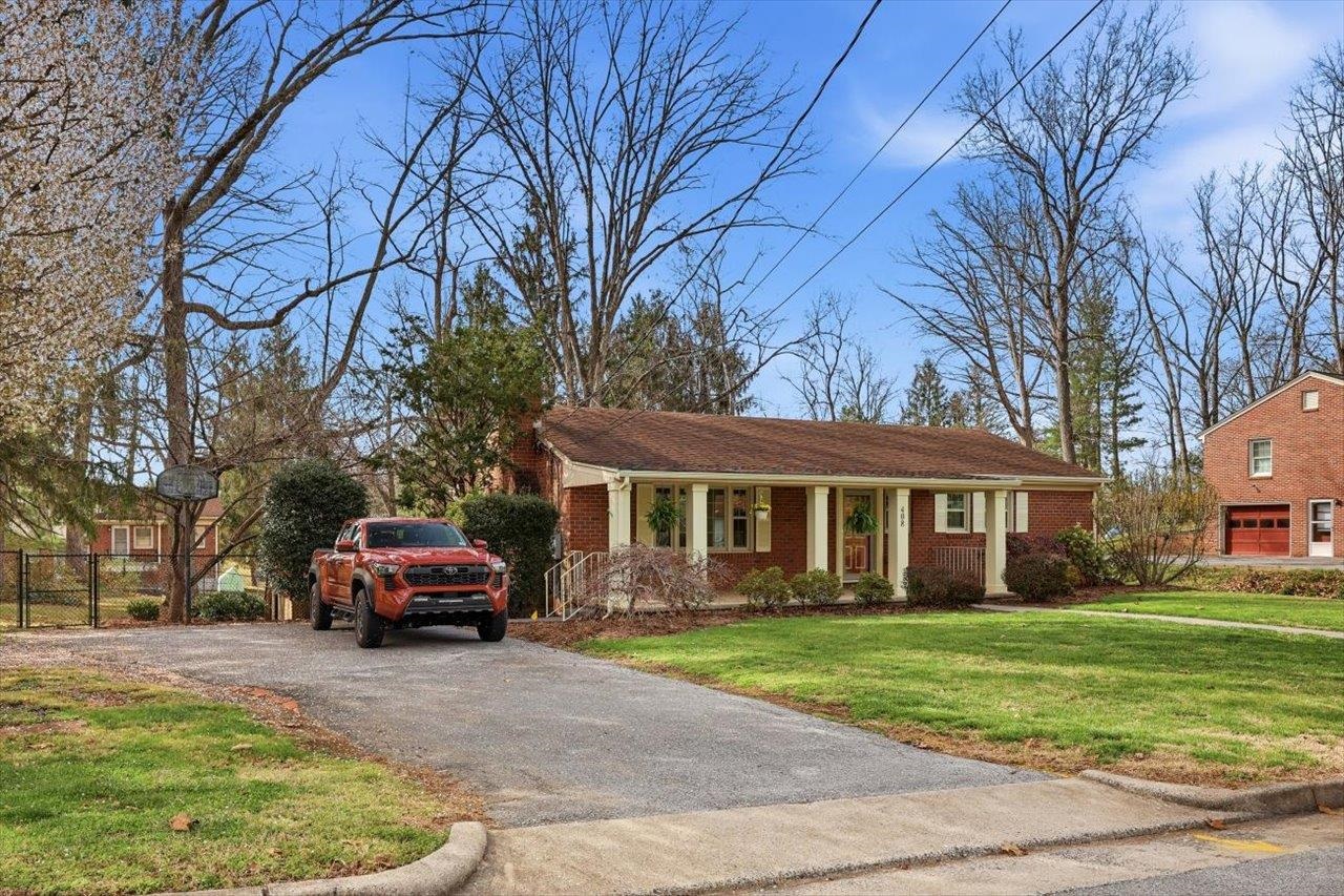 408 Robin Street Staunton, VA 24401 - Photo 35 of 52 a car parked in front of a brick house next to a yard