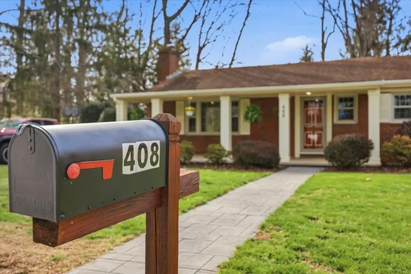 a aerial view of a house with swimming pool next to a yard