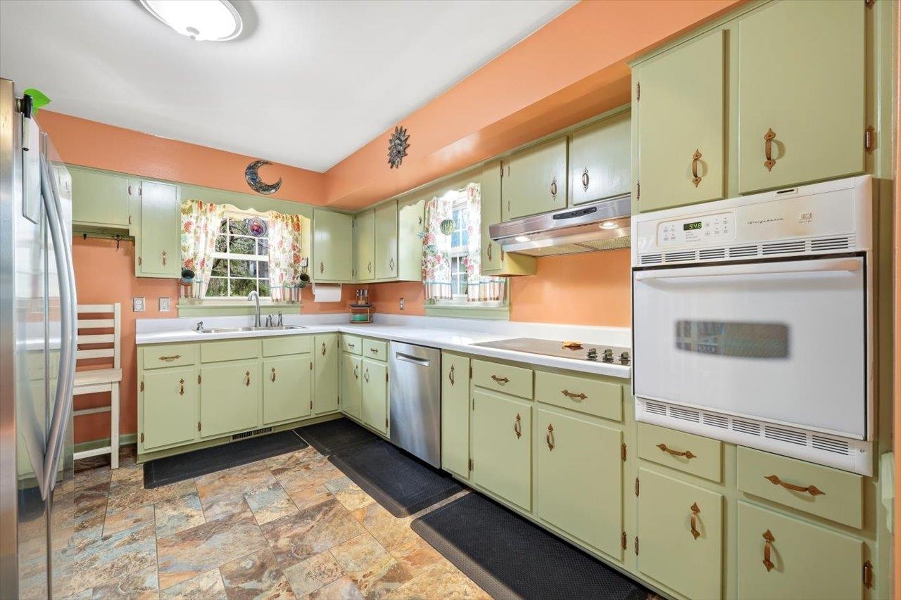 408 Robin Street Staunton, VA 24401 - Photo 10 of 52 a kitchen with cabinets appliances and a large window