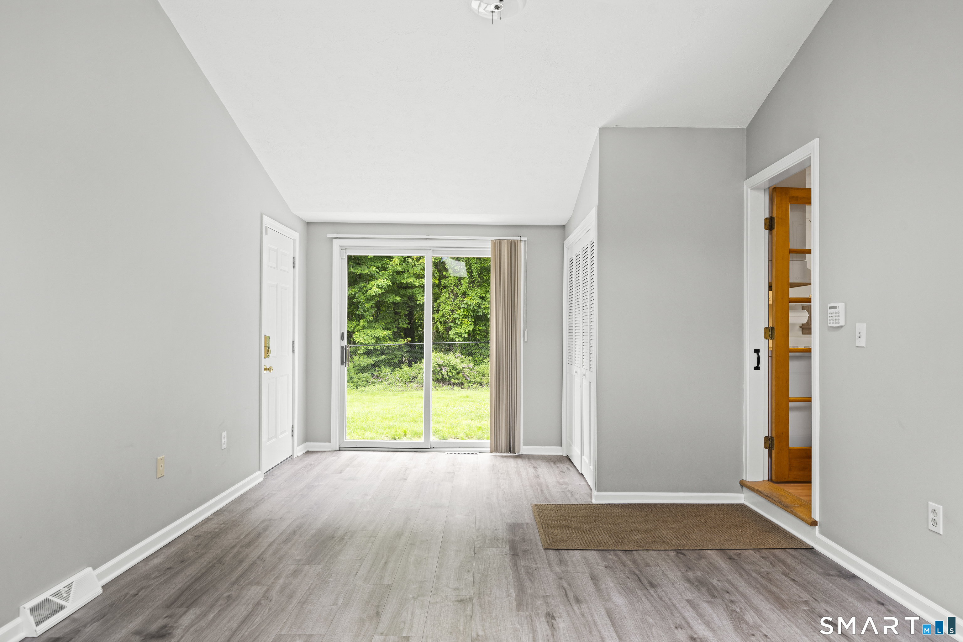 6 Cartier Road Enfield, CT 06082 - Photo 5 of 40 an empty room with wooden floor and windows
