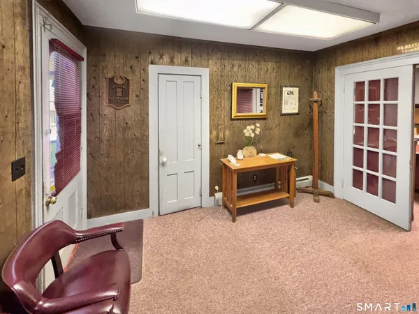 a living room with furniture a flat screen tv and a table