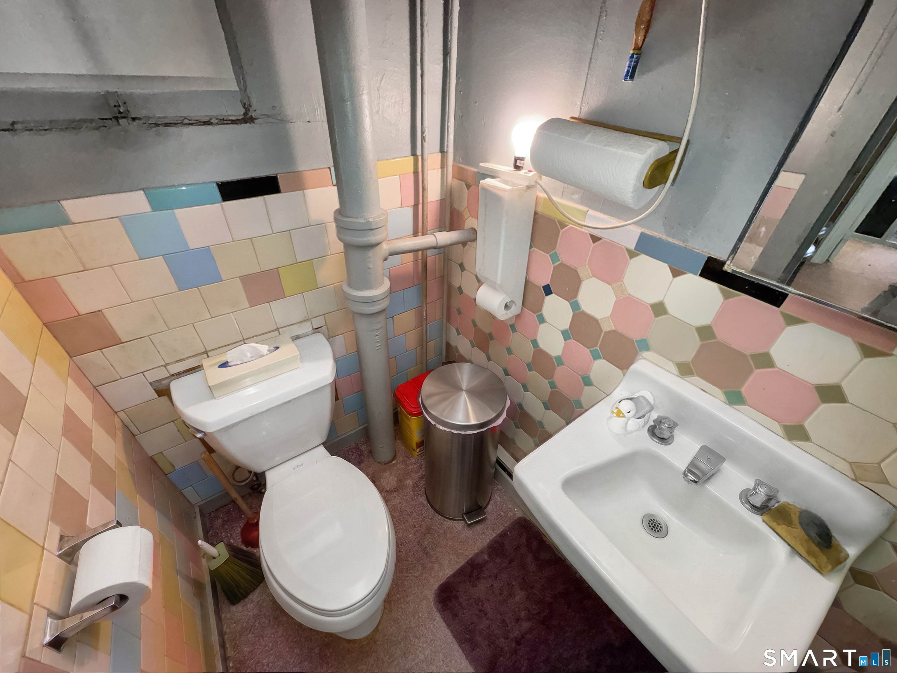 200 West Main Street Meriden, CT 06451 - Photo 44 of 53 a white toilet sitting next to a bathroom sink and a mirror