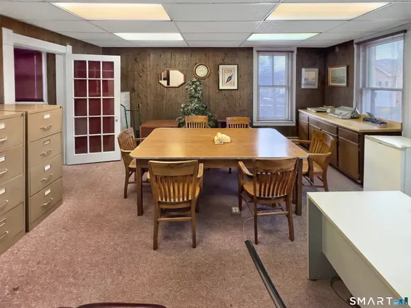 a dining room with furniture and window