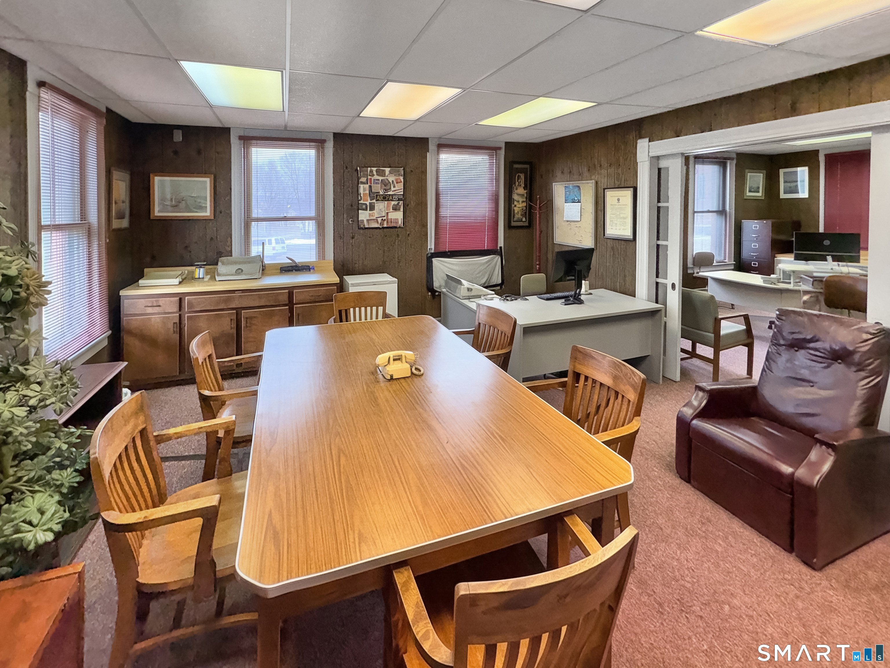 200 West Main Street Meriden, CT 06451 - Photo 49 of 53 a living room with furniture a flat screen tv and kitchen view