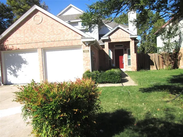 a view of a house with a small yard and a garden