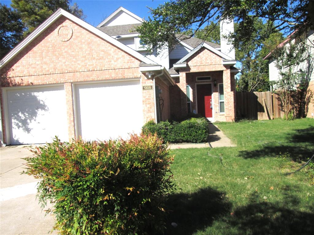a view of a house with a small yard and a garden