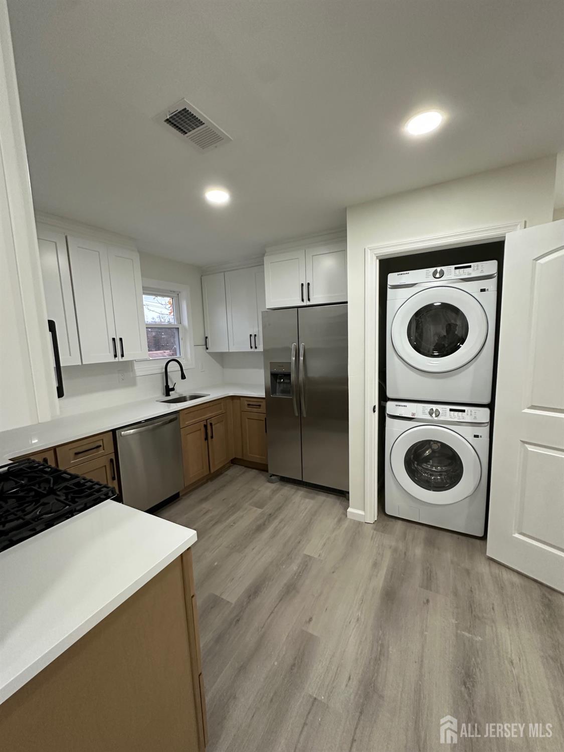 112 Fairview Avenue, Unit 2 Middlesex, NJ 08846 - Photo 13 of 29 a kitchen with stainless steel appliances granite countertop a refrigerator a sink and wooden cabinets