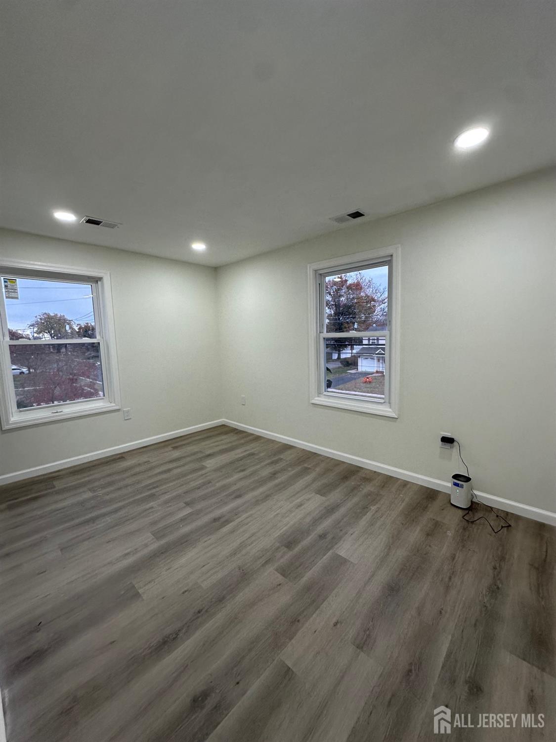 112 Fairview Avenue, Unit 2 Middlesex, NJ 08846 - Photo 27 of 29 an empty room with wooden floor and windows
