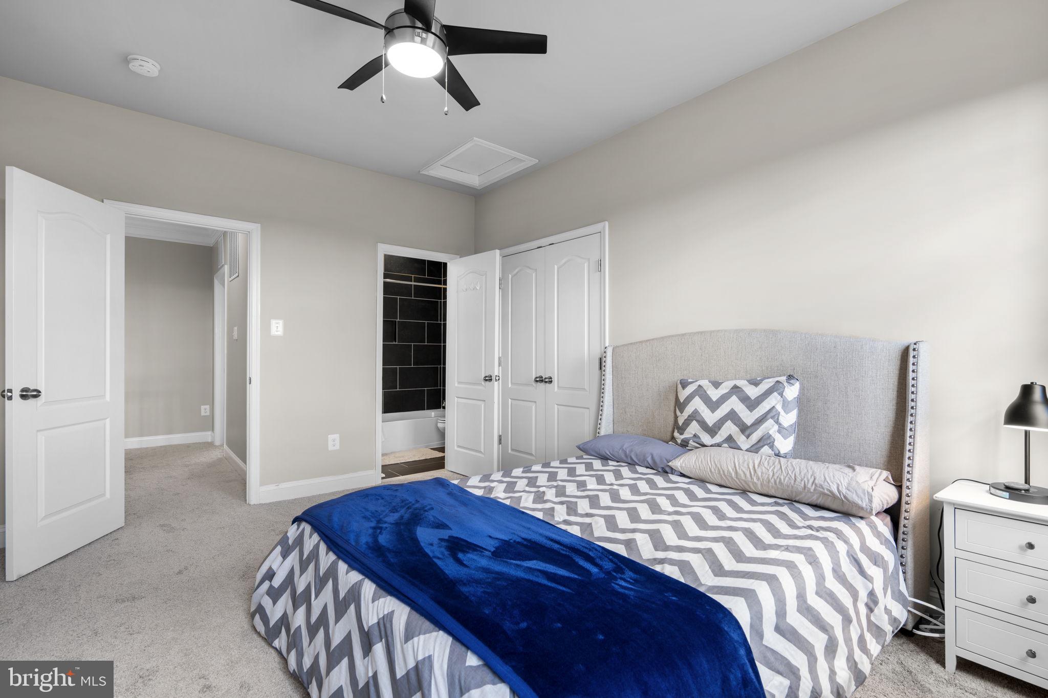 19723 Zion Road Brookeville, MD 20833 - Photo 42 of 67 a bedroom with a large bed and a chandelier