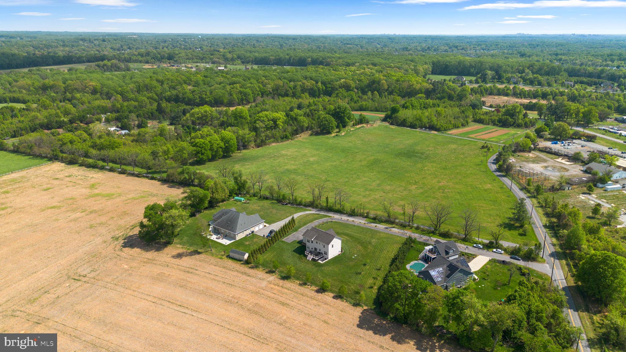 19723 Zion Road Brookeville, MD 20833 - Photo 65 of 67 an aerial view of a forest with houses