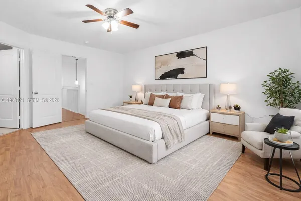a spacious bedroom with a bed and a chandelier