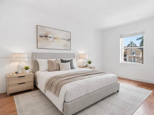 a bedroom with a bed and a painting on the wall