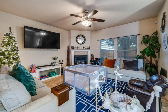 a living room with furniture a rug and a fireplace