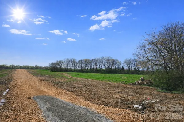 a view of a lake in middle of a yard