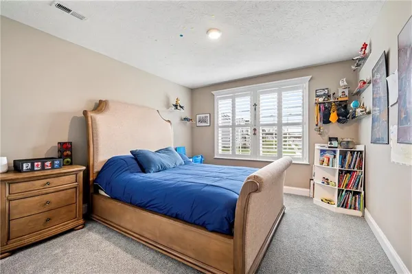 a bedroom with a bed and a book shelf
