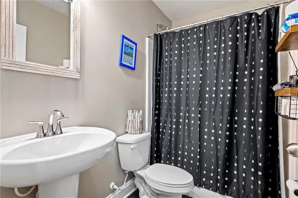 a white toilet sitting next to a bathroom sink