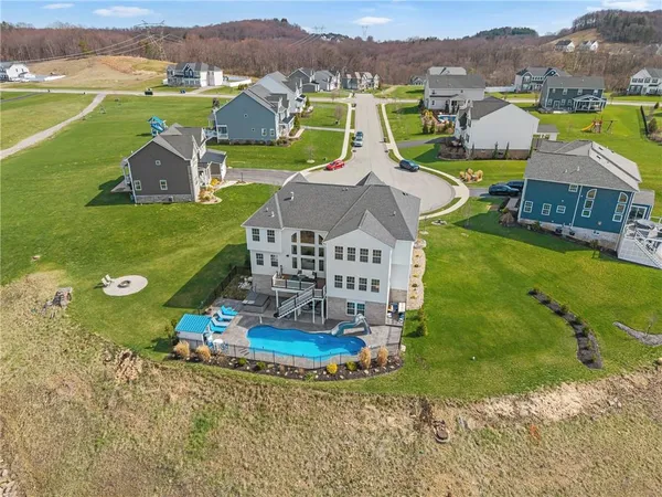 an aerial view of a house with outdoor space swimming pool