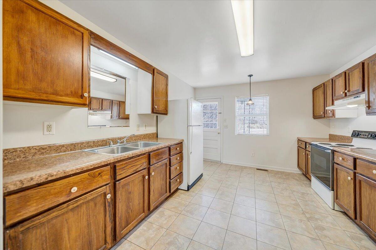 5549 Hollins Road Roanoke, VA 24019 - Photo 13 of 48 a kitchen with a sink stove and cabinets