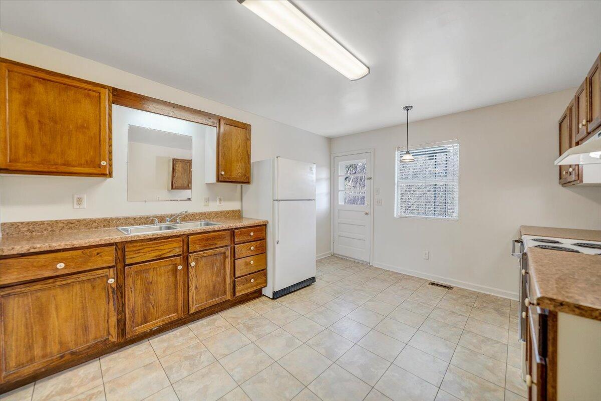 5549 Hollins Road Roanoke, VA 24019 - Photo 14 of 48 a spacious bathroom with a granite countertop sink a mirror and a bathtub