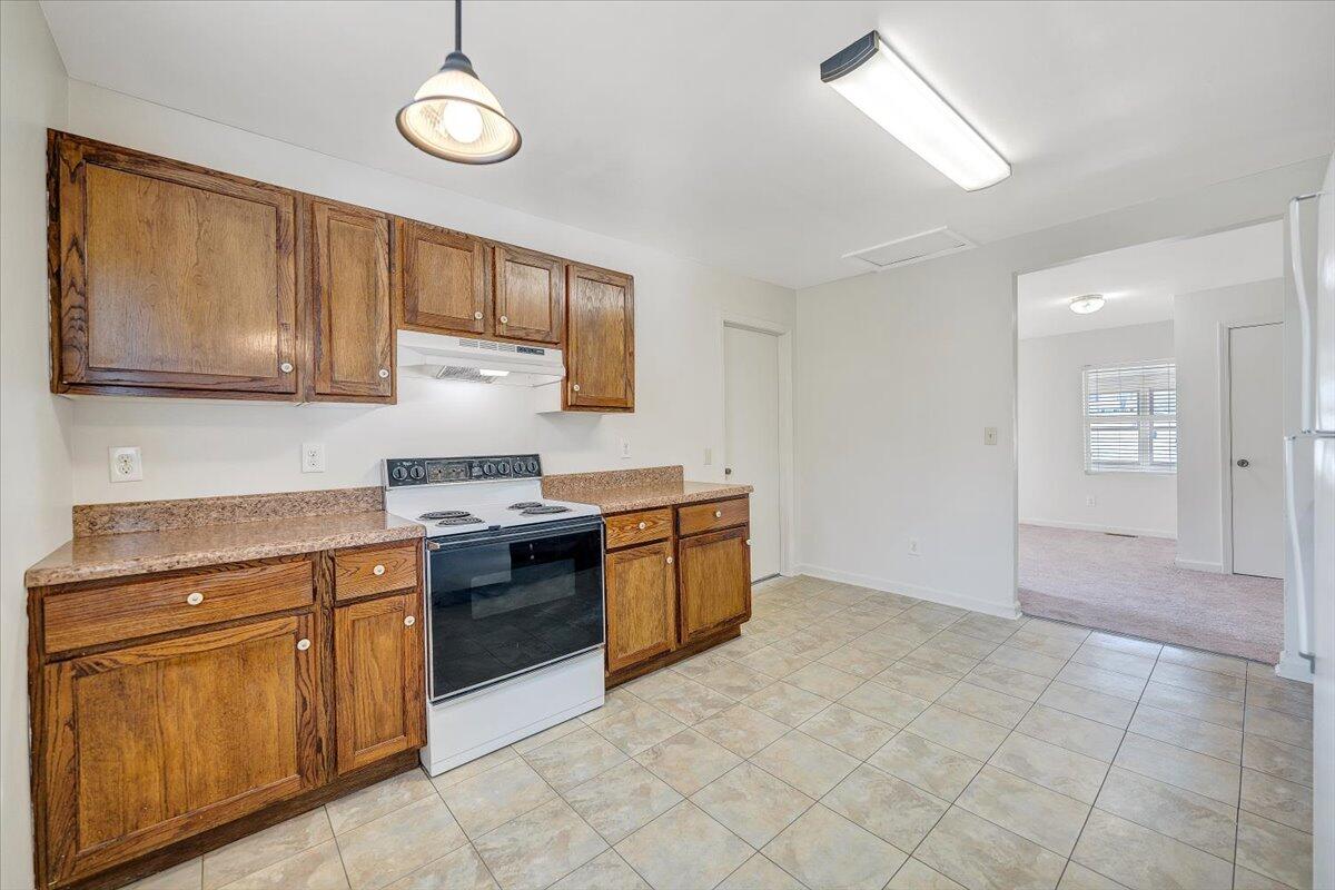 5549 Hollins Road Roanoke, VA 24019 - Photo 17 of 48 a kitchen with stainless steel appliances granite countertop a stove and cabinets
