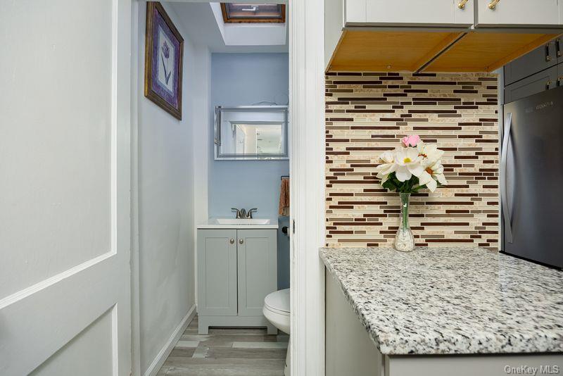 88 Innis Avenue Poughkeepsie, NY 12601 - Photo 11 of 25 a bathroom with a granite countertop sink and a toilet