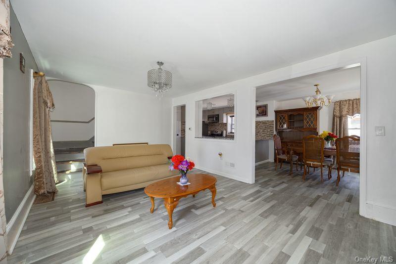 88 Innis Avenue Poughkeepsie, NY 12601 - Photo 12 of 25 a living room with furniture and a dining table with wooden floor