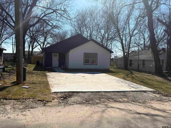 a view of a house with a yard covered in snow