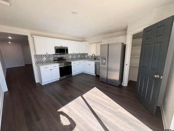 a kitchen with a sink and refrigerator