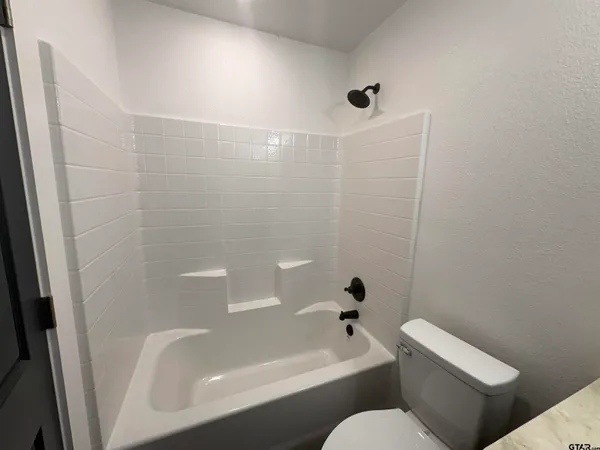 a bathroom with a toilet bathtub and shower