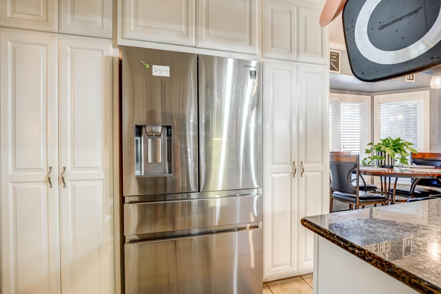 5229 91st Street Lubbock, TX 79424 - Photo 12 of 28 a kitchen with stainless steel appliances granite countertop a refrigerator and a sink