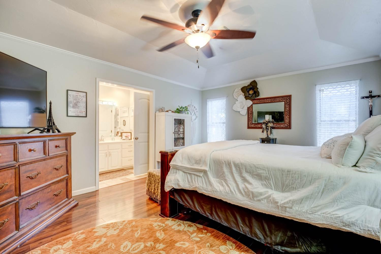 5229 91st Street Lubbock, TX 79424 - Photo 16 of 28 a bedroom with a bed and a flat screen tv