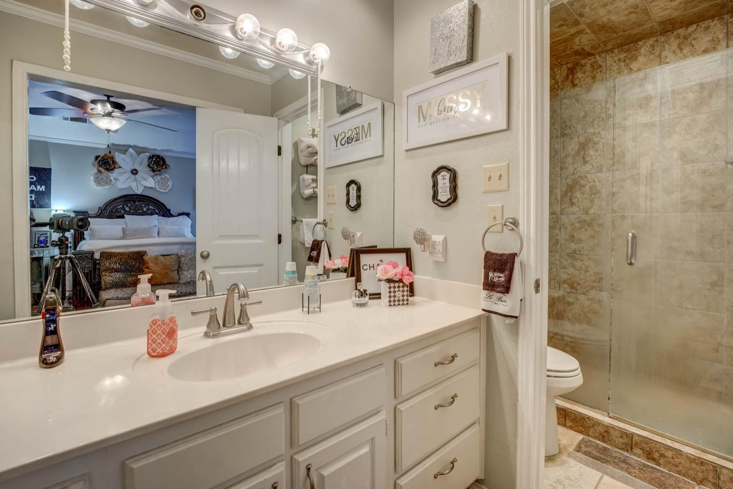 5229 91st Street Lubbock, TX 79424 - Photo 17 of 28 a bathroom with a double vanity sink mirror and shower