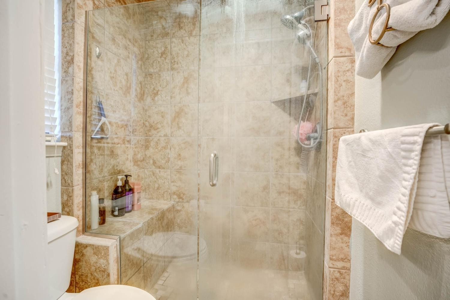 5229 91st Street Lubbock, TX 79424 - Photo 18 of 28 a bathroom with a shower and toilet