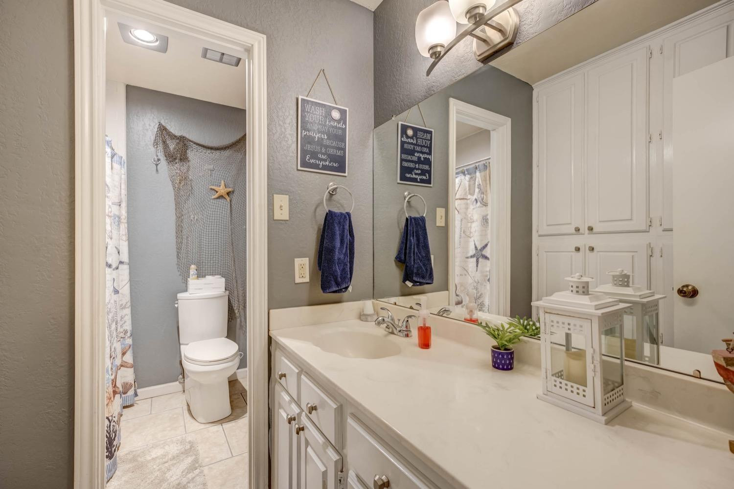 5229 91st Street Lubbock, TX 79424 - Photo 19 of 28 a bathroom with a sink toilet and shower