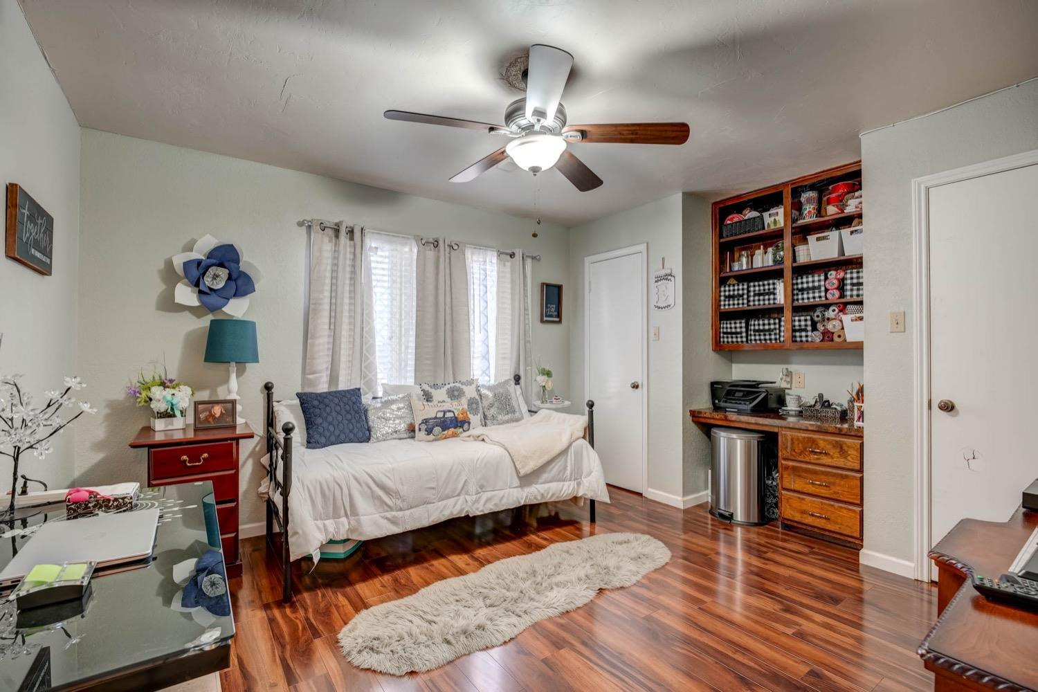 5229 91st Street Lubbock, TX 79424 - Photo 22 of 28 a bedroom with a bed and wooden floor