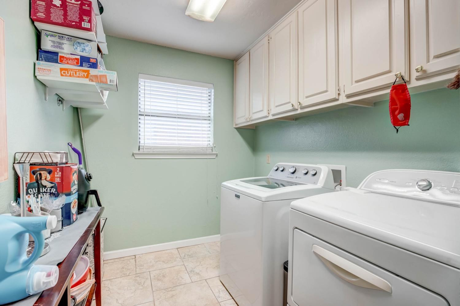 5229 91st Street Lubbock, TX 79424 - Photo 23 of 28 a utility room with dryer washer and a window