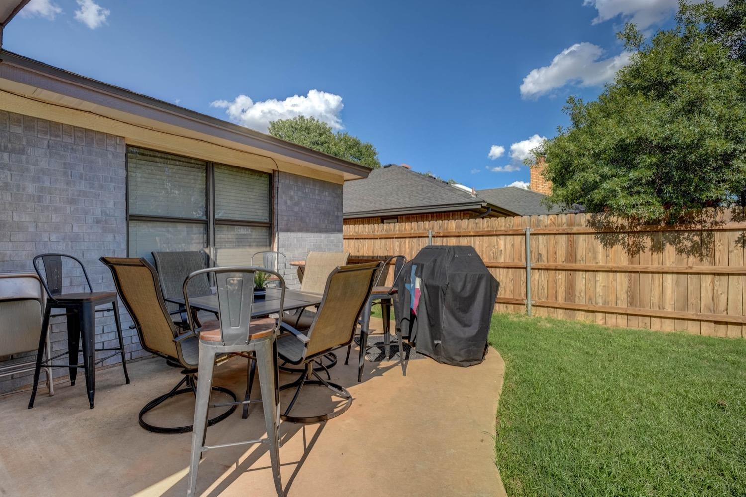 5229 91st Street Lubbock, TX 79424 - Photo 26 of 28 a view of a chairs and table in backyard