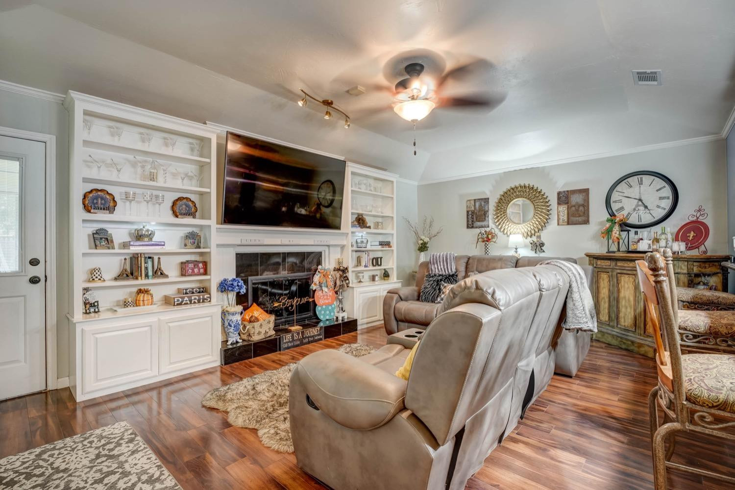5229 91st Street Lubbock, TX 79424 - Photo 4 of 28 a living room with furniture a flat screen tv and a fireplace