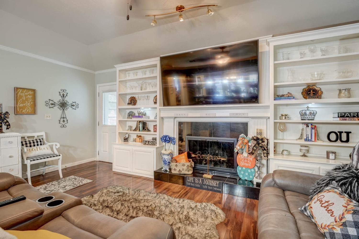 5229 91st Street Lubbock, TX 79424 - Photo 5 of 28 a living room with furniture and a fireplace