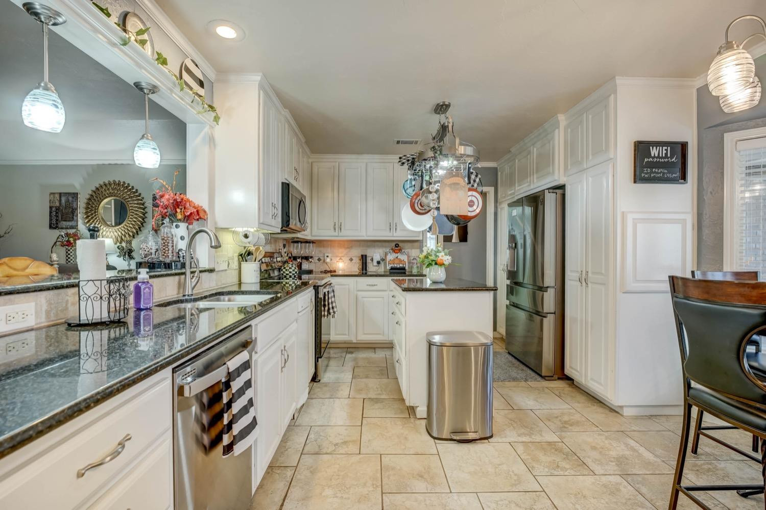 5229 91st Street Lubbock, TX 79424 - Photo 7 of 28 a kitchen with refrigerator and cabinets