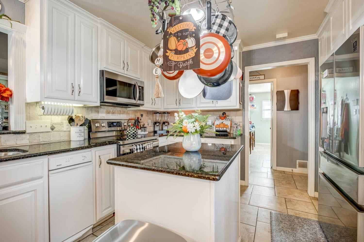 5229 91st Street Lubbock, TX 79424 - Photo 8 of 28 a kitchen with stainless steel appliances granite countertop a sink and a refrigerator