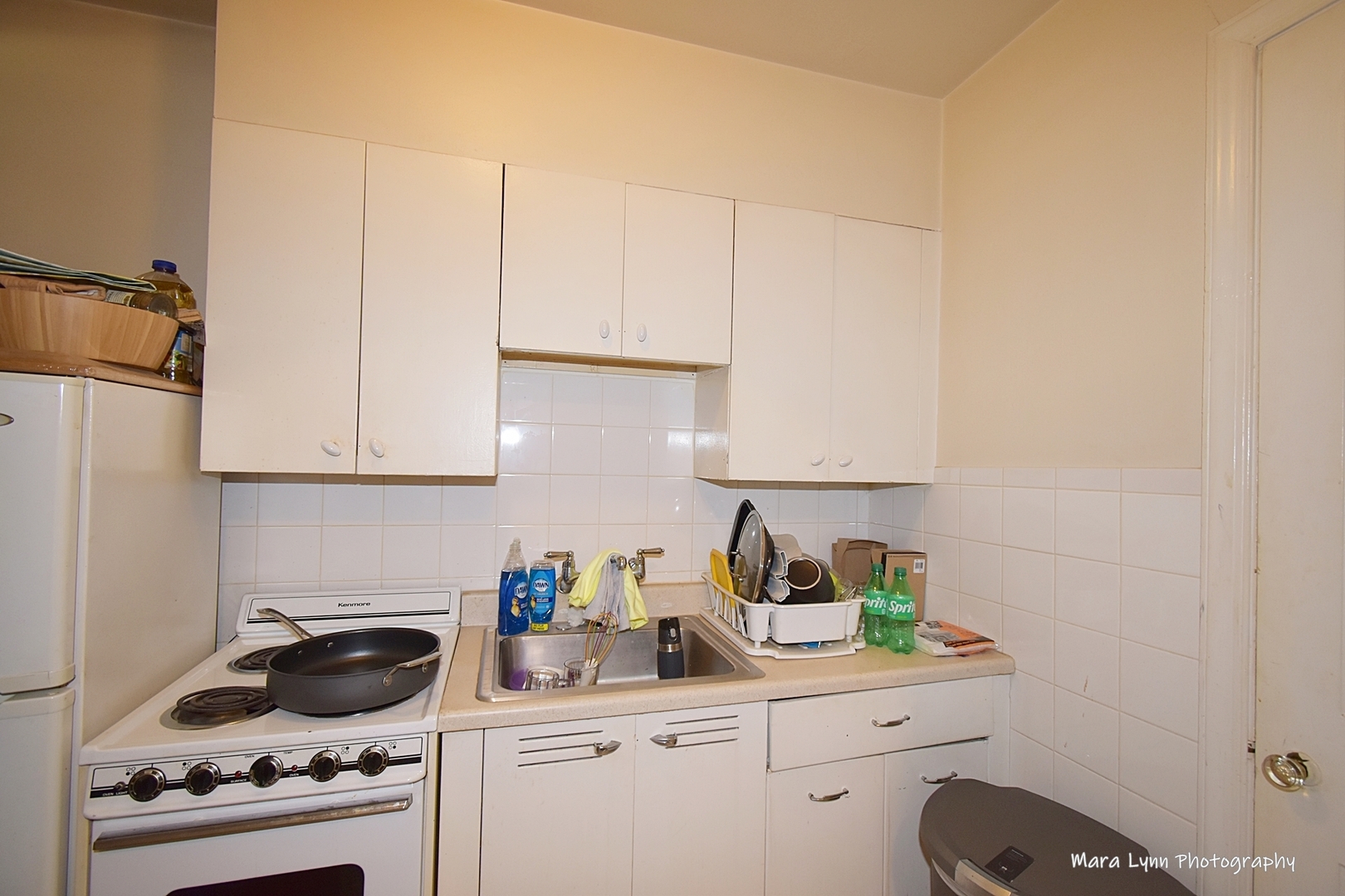 302 Division Street Geneva, IL 60134 - Photo 13 of 25 a kitchen with white cabinets and appliances