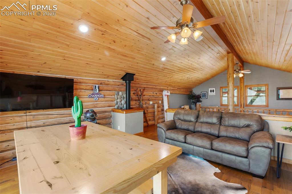 9110 Mountain Road Cascade, CO 80809 - Photo 20 of 49 a living room with furniture and a flat screen tv