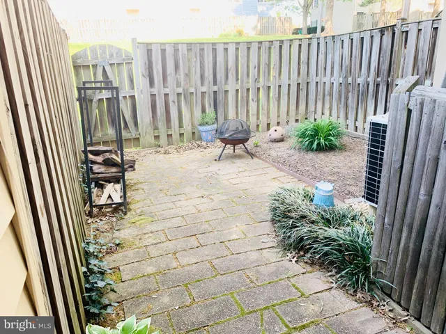 swimming pool view with a chair and table in the back