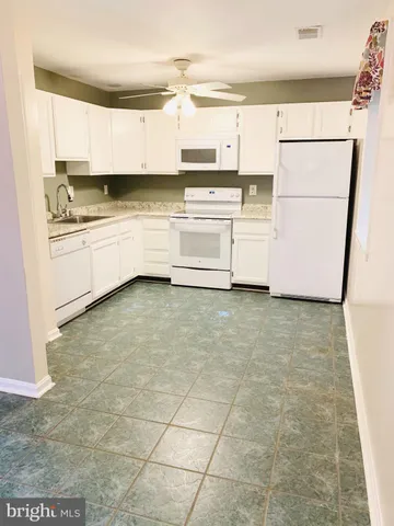 a kitchen with stainless steel appliances a refrigerator sink and cabinets